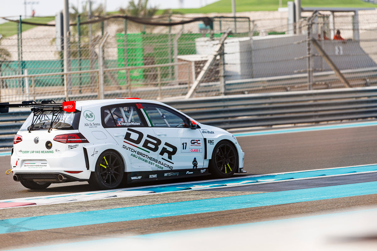 The number 17 Dutch Brothers Racing Golf rounding a corner at Yas Marina Circuit, seen from the rear three-quarter.