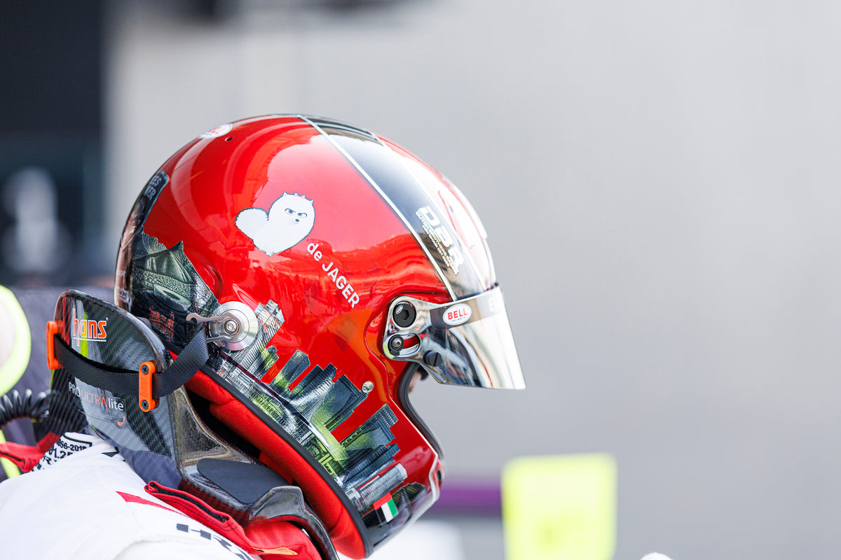 Side view of Jon de Jager's red helmet with his name across the side, worn in the pit lane.