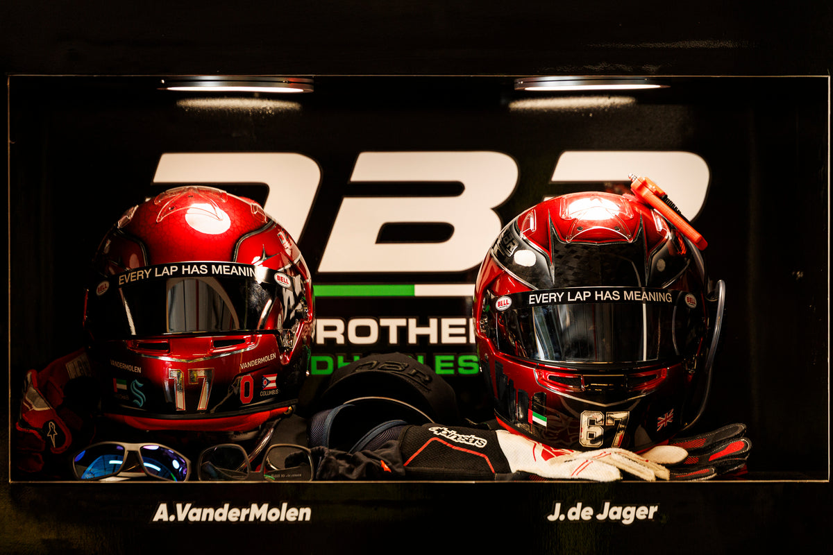 Both Dutch Brothers Racing helmets side by side against the team backdrop, labelled A. VanderMolen and J. de Jager.